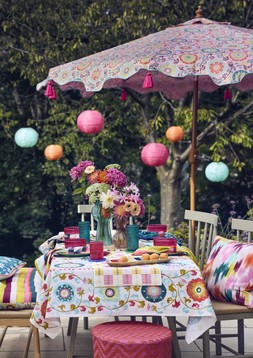 Nylon rope planters, from £12, Cushions, from £15, Beldi floral tablecloth £35, Beldi floral bench pad £45, Beldi floral parasol £89, Paper lanterns, set of 3 £25, Nylon rope lanterns, from £12 & Giant daisy stake £22